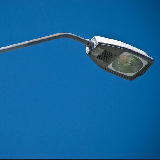  Street light seen from below against a clear blue sky